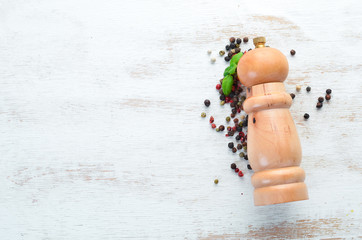 Mill pepper and pepper. Spices Top view. On the old background.