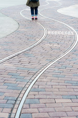 Fototapeta premium Unidentified people standing on curve walk way on brick block.