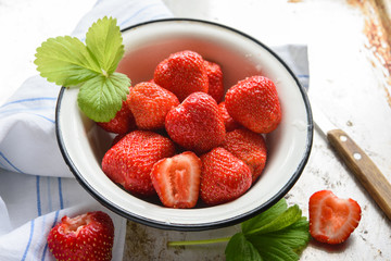 Summer mood: red strawberry in old bowl