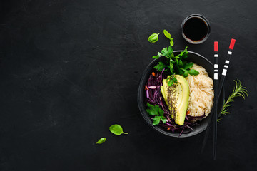 Rice with avocado and cabbage. Healthy food. Top view. On a black background. Free copy space.