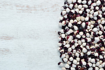 Raw beans on a white wooden background. Top view. Free copy space.