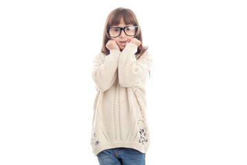 Surprised little girl in glasses pressed her hands to her face.