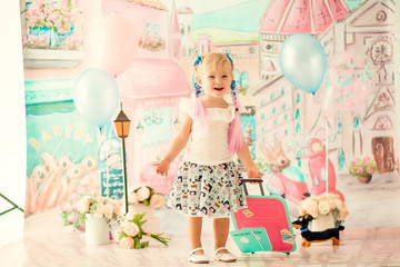Portrait of a little cheerful birthday girl with the first cake. Eating the first cake. Smash cake.