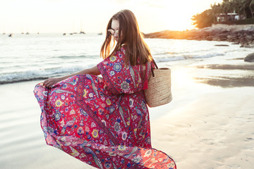 Beautiful girl in boho maxi dress on the beach - obrazy, fototapety, plakaty