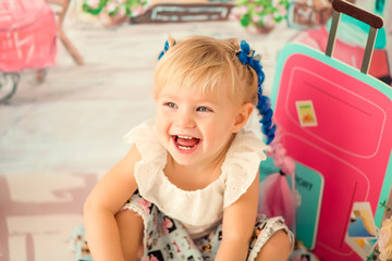 Portrait of a little cheerful birthday girl with the first cake. Eating the first cake. Smash cake.
