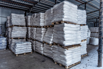 White polyethylene bags with factory products in warehouse