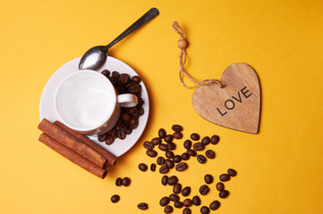 Composition: a wooden heart and a cup of coffee