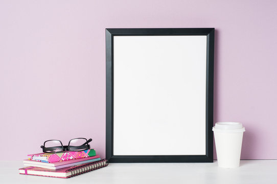 black picture frame mockup with a pink background and a takeout coffee cup
