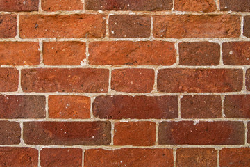 Old red brick wall with traces of repair