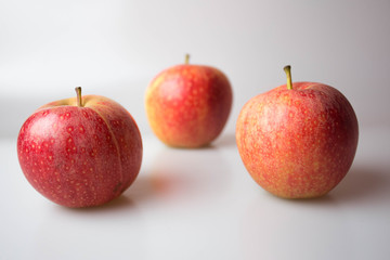 red apples on white background blur 3