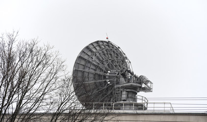 Large satellite dish on the roof of the building