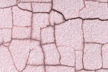 Texture of a pink cracked wall