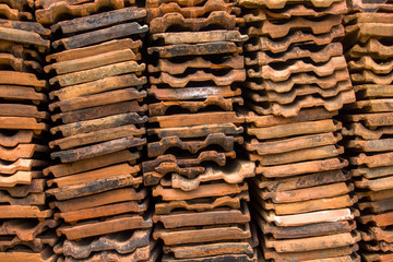 red tiles lie in rows close-up. rough surface texture