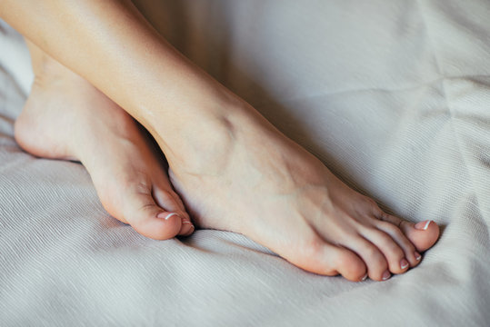 Young girl resting on bed, girl's legs lie on bed