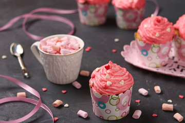 Homemade cupcakes with cream on a dark background. Concept for Valentine's Day, Birthday, March 8 and Mother's Day