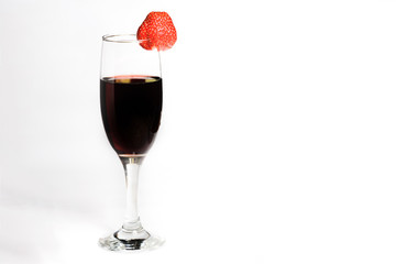 A glass of red wine with strawberries on a white background