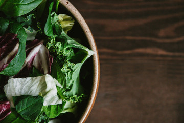 Green vegan Breakfast in a bowl with various leaves, top view. Clean eating, dieting, vegan...