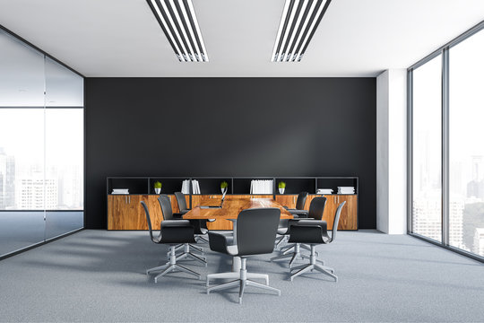 Black meeting room with wooden table