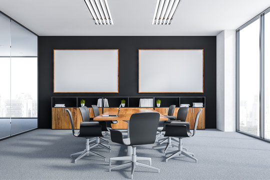 Black meeting room with two posters