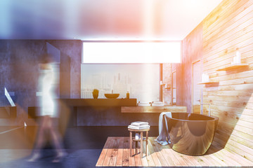 Woman in concrete and wood bathroom interior