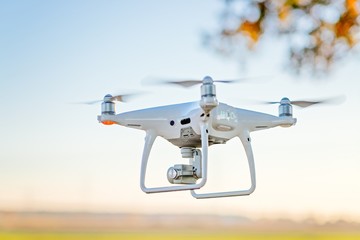 Professional drone with camera in flight