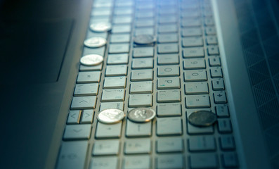 Coins on keyboard - blue light