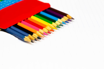 Colored pencils with light background. Back to school. School supplies. Space for text