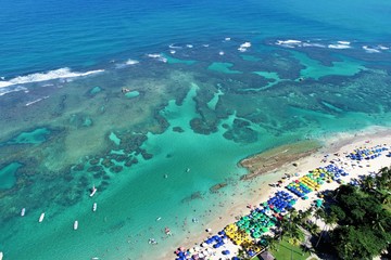 Aerial view of Porto de Galinhas beaches, Pernambuco, Brazil: unique experience of swimming with fishs in natural pools.  Beautiful landscape. Candles, sailboats, rafts, boats in the harbor!