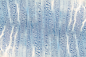 Texture of rain drops on a glass wet transparent surface.
