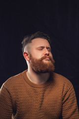 Cheerful bearded man greets by taking off a hat - studio shots