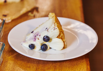 Blueberry cake and fruit chocolate cakes are being served in restaurant
