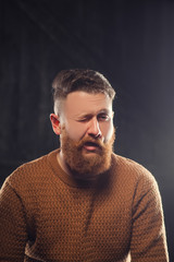 Fototapeta premium Cheerful bearded man greets by taking off a hat - studio shots