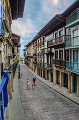 Fototapeta premium Narrow street of Hondarribia with its colorful picturesque houses