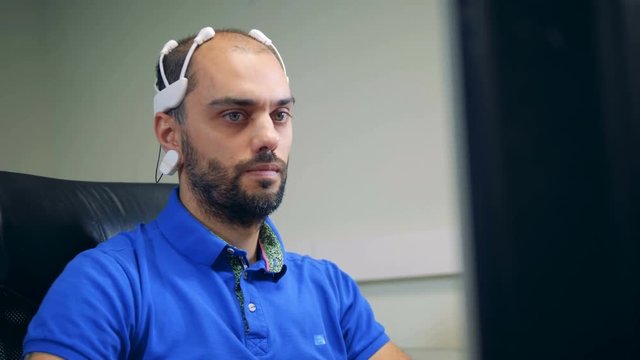 A person using head sensors to check brainwork, close up.