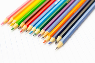 Fototapeta premium Colored pencils with light background. Back to school. School material for learning. Space for text