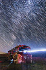 Old bus at the starry night. Beautiful star trails. Armenia.