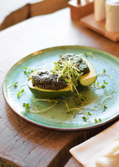 Avocado with Chia seeds on a large flat plate. The concept of healthy eating, vegetarianism, veganism and diet food