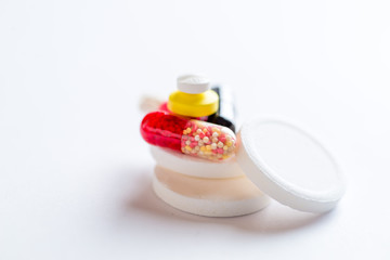 set of multi-colored pills and capsules on a white background