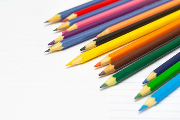 Fototapeta premium Colored pencils with light background. Back to school. School supplies. Space for text