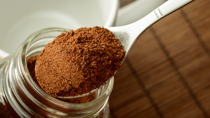 Making coffee in the morning. Taking spoon of coffee out of jar. Putting coffee to the cup