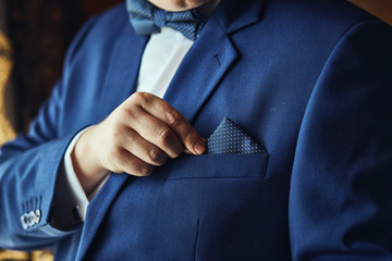 Businessman wears a jacket,male hands closeup,groom getting ready in the morning before wedding ceremony. Men Fashion