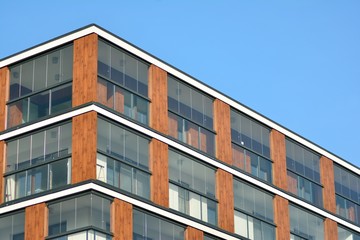 Obraz premium Modern apartment buildings on a sunny day with a blue sky. Facade of a modern apartment building