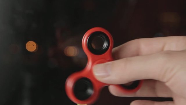man playing with red spinner