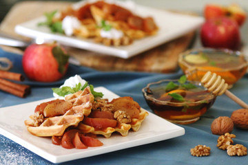 waffles sered with walnuts, honey and baked aples