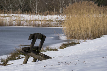 Bench on the shore of a frozen pond © Emil