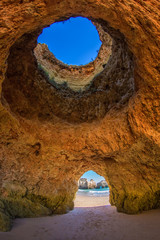 Famous caves in a beach rock formation in the Algarve, Portugal. Through the one cave you can see...