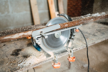 circular saw for working with wood with metal fixed on the table, a working tool for working in...