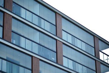 Obraz premium Modern apartment buildings on a sunny day with a blue sky. Facade of a modern apartment building