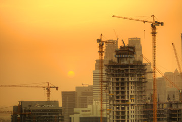 Fototapeta na wymiar Construction zone with cranes building skyscrapers