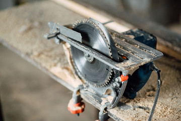 circular saw for working with wood with metal fixed on the table, a working tool for working in construction